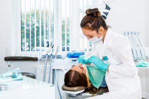 patient receiving a dental cleaning from her dentist
